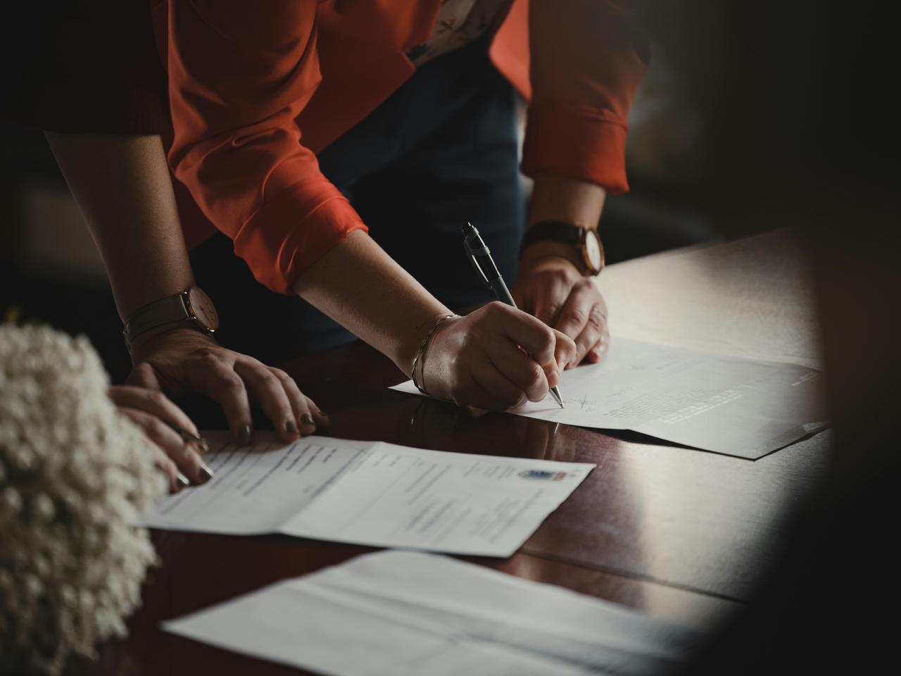 Employee signing an employment contract at a business desk