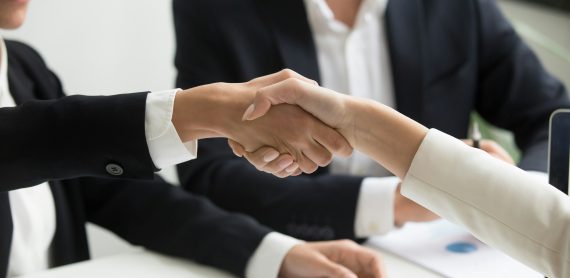 Business handshake symbolizing employment contract transfer in Turkey